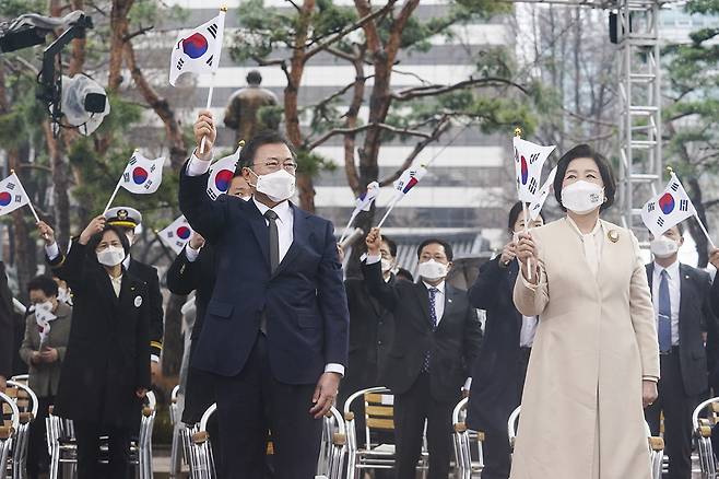 President Moon Jae-in and first lady Kim Jung-sook wave the Korean flag at a ceremony marking the 102nd anniversary of the March 1 Independence Movement in Seoul on Monday. (Cheong Wa Dae)