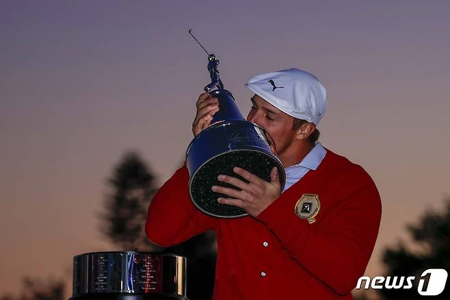 브라이슨 디섐보가 8일(한국시간) PGA투어 아널드 파머 인비테이셔널에서 우승한 뒤 트로피에 입을 맞추고 있다. © AFP=뉴스1