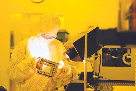 A researcher at ISC examines a component for semiconductor test socket at the company's factory in Ansan, Gyeonggi. [ISC]