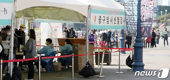 19일 오전 서울 중구 서울역 광장에 마련된 중구 임시선별진료소에서 시민들이 검체 검사를 받기 위해 줄 서서 대기하고 있다. 2021.4.19/뉴스1 © News1 김진환 기자