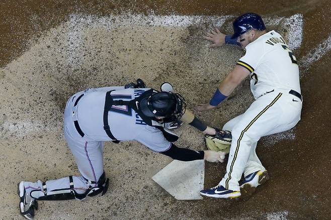 Miami Marlins catcher Chad Wallach tags out Milwaukee Brewers‘ Daniel Vogelbach at home during the sixth inning of a baseball game Wednesday, April 28, 2021, in Milwaukee. (AP Photo/Morry Gash)