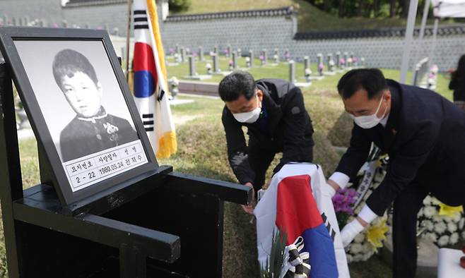 5일 광주 북구 국립 5·18 민주묘지에서 고(故) 전재수 군의 추모제가 열리고 있다. 5·18 당시 초등학교 4학년이었던 전 군은 계엄군이 쏜 총에 맞아 숨졌다. 제대로 된 사진 한장 남기지 못해 묘비 사진을 무궁화로 대체했다가 41년만에 유족이 사진을 발견하면서 이날 묘비 제막식 및 추모식을 열었다. 연합뉴스