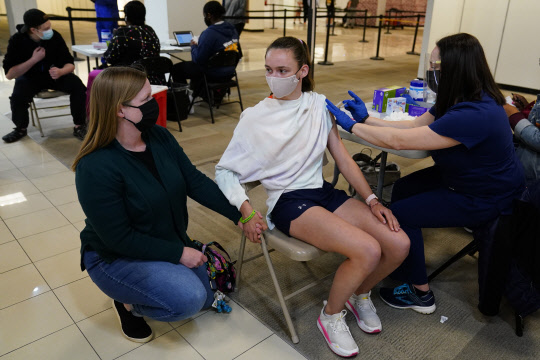 미국 펜실베이니아주의 한 중학교에서 12일(현지시간) 15세 학생이 화이자 백신을 접종하고 있다. <AP, 연합뉴스>
