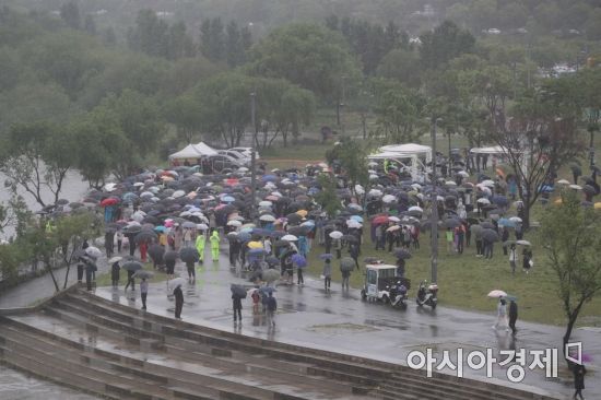 전국에 비가 내린 16일 서울 반포한강공원 수상택시 승강장 인근에서 열린 '고 손정민 군을 위한 평화집회'에서 참가자들이 우산을 쓴 채 사건의 진상규명을 촉구하고 있다. /문호남 기자 munonam@