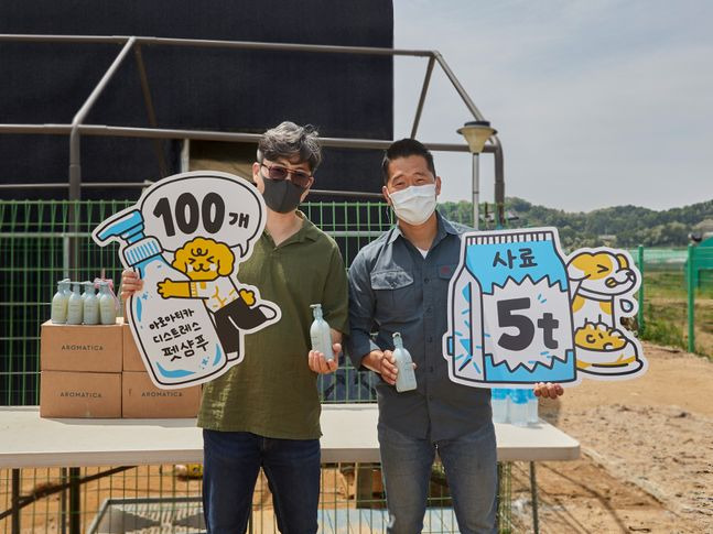 (왼쪽부터) 김영균 아로마티카 대표와 강형욱 훈련사가 유기견 보호소에 사료 5톤과 펫 샴푸 100개를 기부하고 기념촬영을 하고 있다.ⓒ아로마티카