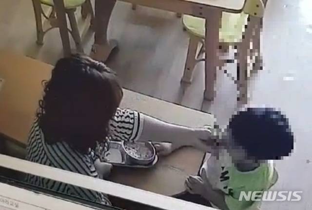 [서울=뉴시스] 경남 사천에 위치한 어린이집이 제공한 폐쇄회로(CC)TV 영상. 해당 영상에는 한 보육교사가 밥 먹기를 거부하면서 고개를 돌리는 아이의 입 안에 음식을 억지로 밀어넣고, 손등을 수차례 내려치는 등의 모습이 담겨있다. 2020.10.28. (사진 = CCTV 영상 갈무리)