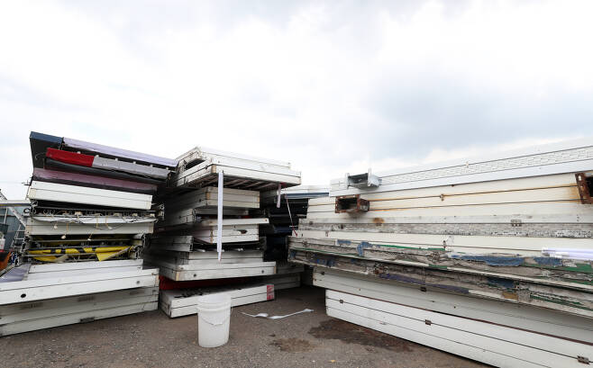 A pile of sign boards is seen at a dumpsite in Bucheon, Gyeonggi Province, on Wednesday, as the prolonged pandemic has forced thousands of stores to shut down. (Yonhap)