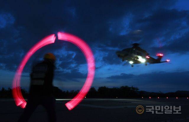 인천 영종도 해경 항공구조대 활주로에서 지난 19일 헬기가 야간 순찰 비행을 위해 이륙하고 있다. 붉은 원처럼 보이는 것은 신호수가 양손에 지시봉을 들고 머리 위로 올렸다 내리기를 반복하며 이륙신호를 보내는 모습. 3700시간 조종 경력을 가진 항공구조대 이진보 경감은 “야간의 해상에선 시야가 차단돼 비행착각을 일으키기 쉽다”며 야간 작전의 위험성을 설명했다.