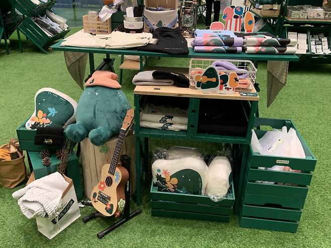 Soop T-shirts and sweatpants and a plush toy Soopy are displayed with other merchandise. (Park Jun-hee/The Korea Herald)