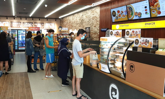 People shop at the third Emart24 store in Malaysia on Wednesday. [EMART24]