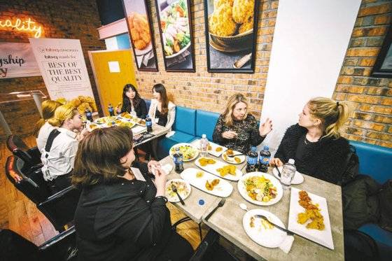 BBQ가 현지 맞춤형 마케팅으로 미국 등 글로벌 시장에서 급성장하고 있다. BBQ 직영점인 미국 맨해튼 K-타운점에서 현지 고객들이 한국 치킨의 매력을 만끽하고 있다. [사진 제너시스BBQ]