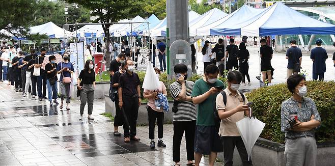지난달 25일 경기도 성남시 야탑역에 마련된 선별진료소에 검사를 받으려는 시민들이 줄지어 서있다. 성남(경기)=이동근기자 foto@etnews.com