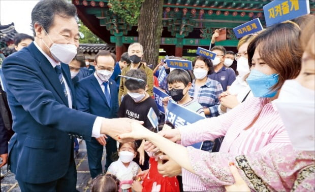 < 시민과 악수 > 이낙연 전 더불어민주당 대표가 22일 전주시 한옥마을에서 시민들과 악수하고 있다.  뉴스1