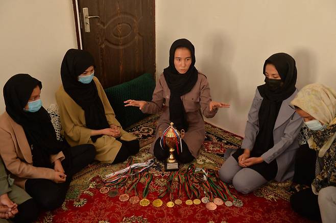 태권도 챔피언 자르군나 누리(가운데)가 헤라트주의 한 주택에서 태권도 아카데미 회원들과 이야기를 하고 있다. AFP=연합뉴스