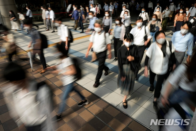 일본 도쿄 시나가와역 인근에서 마스크를 쓴 시민들이 걸어가고 있다. /AP=뉴시스