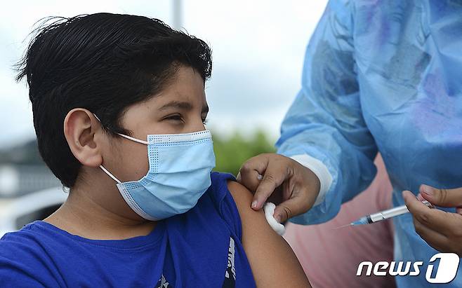 26일(현지시간) 온두라스 테구시갈파에 마련된 코로나19 백신 접종소에서 청소년이 화이자 백신을 맞고 있다. © AFP=뉴스1 © News1 우동명 기자