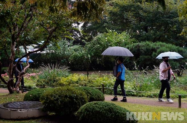 서울 여의도 국회에서 시민들이 우산을 쓰고 발걸음을 재촉하고 있다.   사진=박효상 기자