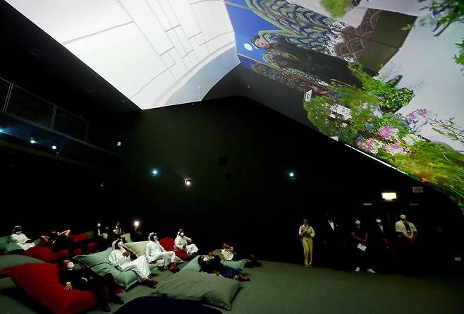 Visitors watch “the Journey of Wonder,” at the Vertical Cinema inside Korea Pavilion at the Expo 2020 Dubai. (Courtesy of Kotra)