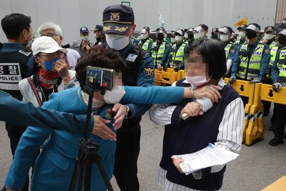 11일 오후 서울 여의도 더불어민주당사 앞에서 이낙연 후보 지지자들이 대선 후보 경선 무효표 처리 이의제기 관련 기자회견을 하는 가운데 이재명 후보 지지자(오른쪽)가 유튜브 중계를 하자 저지하고 있다. 연합뉴스