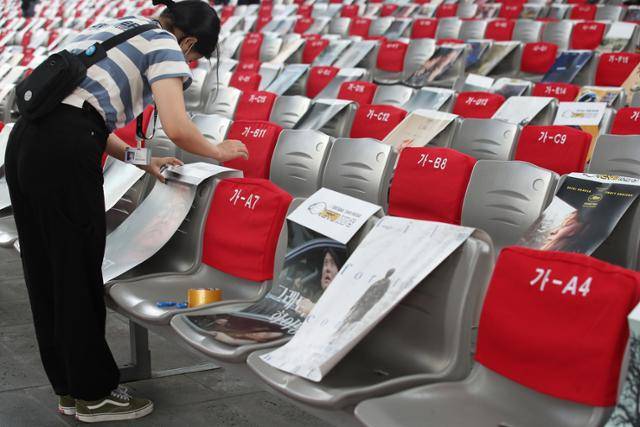 제26회 부산국제영화제 폐막식이 열리는 15일 해운대구 영화의전당에서 영화제 관계자가 객석에 참석자의 사회적 거리두기를 위해 영화 포스터를 붙이고 있다. 연합뉴스