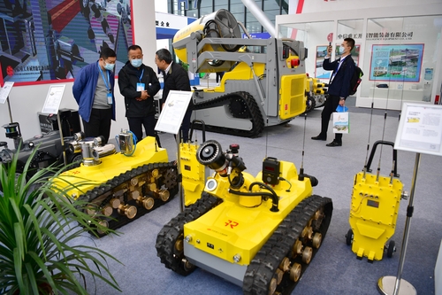 Visitors learn about various kinds of mining robots at the exhibition.