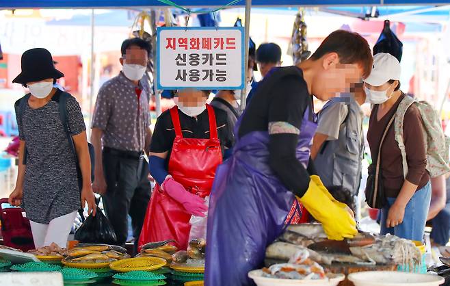 추석을 앞둔 경기도 성남시 모란민속5일장의 한 생선가게에 지역화폐 및 신용카드 사용 가능 안내문이 걸려 있다. /연합뉴스