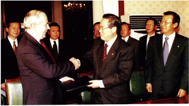 이경식(앞줄 맨 오른쪽) 한국은행 총재와 임창열(가운데) 경제부총리가 1997년 12월 3일 정부 세종로청사에서 국제통화기금(IMF) 긴급자금을 지원받기 위한 정책의향서에 서명한 후 캉드쉬 IMF 총재와 악수를 나누고 있다. 한국일보 자료사진