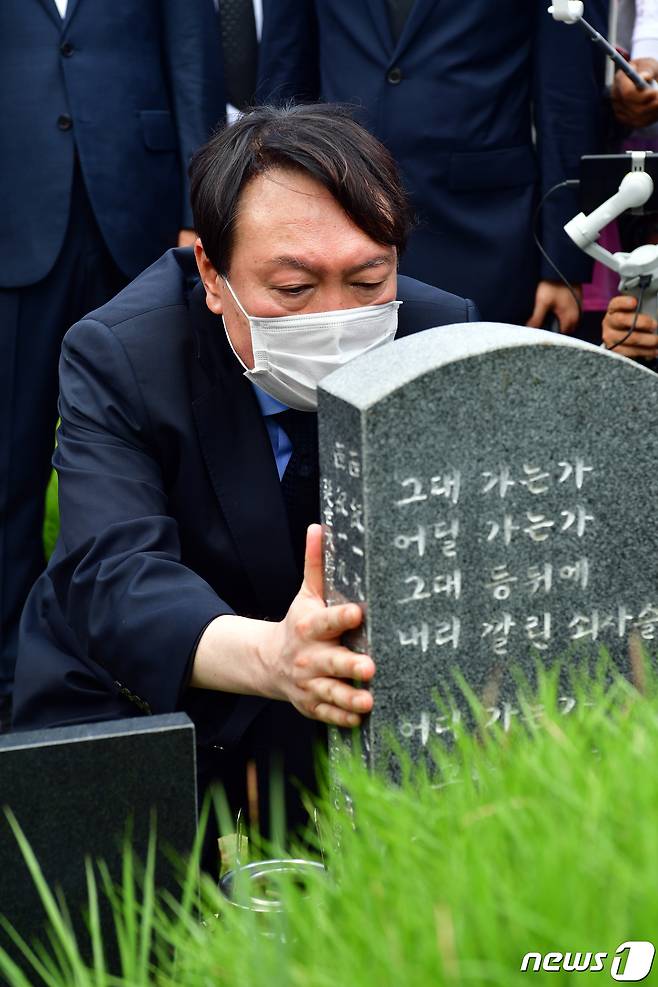 대권 도전에 나선 윤석열 전 검찰총장이 17일 오전 광주 북구 망월동 민족민주열사묘역(5·18 구 묘역)에서 이한열 열사 묘비를 어루만지고 있다. 2021.7.17/뉴스1 © News1 황희규 기자