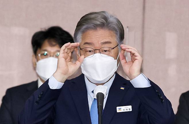 Democratic Party presidential nominee Lee Jae-myung adjusts his glasses while attending the 2021 parliamentary audit of Gyeonggi Province by the National Assembly’s Public Administration and Security Committee on Monday morning. (pool photo)