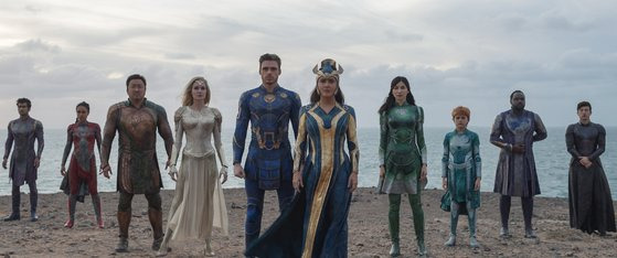 (L-R): Kingo (Kumail Nanjiani), Makkari (Lauren Ridloff), Gilgamesh (Don Lee), Thena (Angelina Jolie), Ikaris (Richard Madden), Ajak (Salma Hayek), Sersi (Gemma Chan), Sprite (Lia McHugh), Phastos (Brian Tyree Henry) and Druig (Barry Keoghan) in Marvel Studios' ETERNALS. Photo courtesy of Marvel Studios. ㎝arvel Studios 2021. All Rights Reserved.