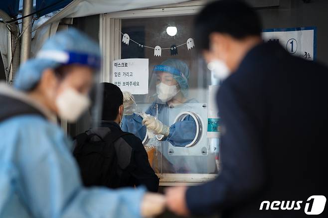 20일 서울역광장에 마련된 신종 코로나바이러스 감염증(코로나19) 중구 임시선별검사소를 찾은 시민들이 검체 검사를 받고 있다. 질병관리청 중앙방역대책본부는 20일 0시 기준 코로나19 신규 확진자가 1571명 발생했다고 밝혔다. 이는 어제보다 498명 증가한 수치다. 2021.10.20/뉴스1 © News1 유승관 기자