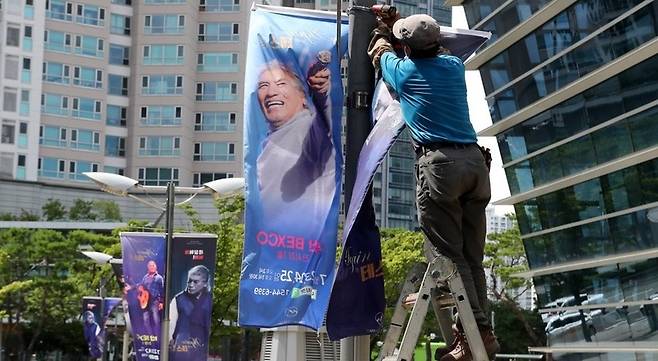 지난 7월 22일 부산 해운대구 벡스코에서 가수 나훈아 공연 홍보 현수막이 철거되고 있다. / 사진 = 연합뉴스