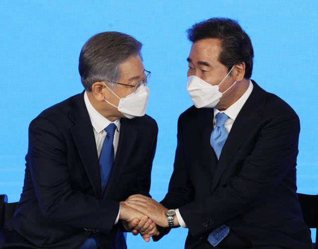 더불어민주당 제20대 대통령 후보에 선출된 이재명 경기도지사가 10일 오후 서울 송파구 올림픽공원 SK올림픽핸드볼경기장에서 열린 서울 합동연설회에서 이낙연 경선 후보의 축하를 받고 있다. /권욱 기자