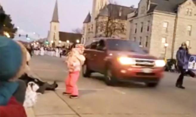 지난 21일(현지시간) 사고 현장이 촬영된 동영상 화면. 붉은색 SUV 차량이 어린 여자아이 옆을 지나며 돌진하고 있다. 워키쇼=AP뉴시스