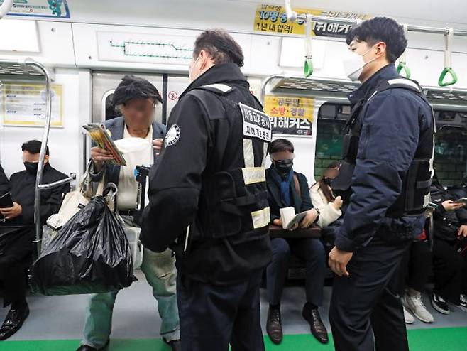 지난 22일 밤 서울 지하철 2호선 열차 안에서 지하철 보안관 이건영씨가 마스크를 쓰지 않은 잡상인을 단속하고 있다. /장련성 기자