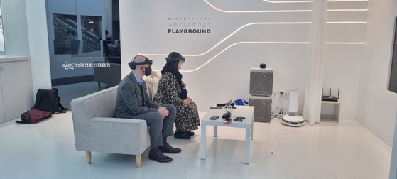 Reporters sit down in the living-room-like space within the Metaverse Playground wearing augmented reality (AR) gears, where a virtual avatar performs some tricks to illustrate how the internet of things (IoT) works. [MINISTRY OF SCIENCE AND ICT]