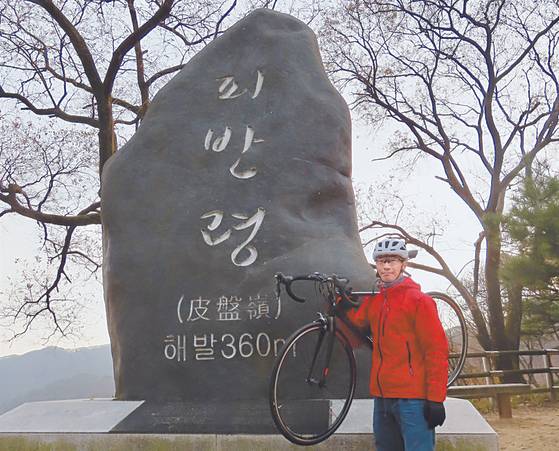 A visitor to Piballeyong poses in front of a name stone [KIM HONG-JUN]
