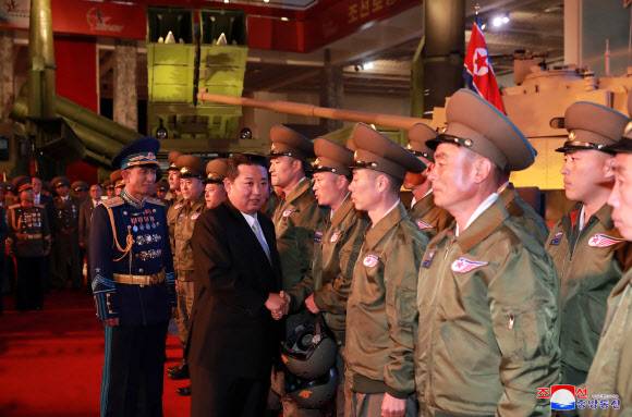 - 북한이 노동당 창건 76주년을 맞아 국방발전전람회 ‘자위2021’을 지난 11일 3대혁명 전시관에서 개막했다고 조선중앙통신이 12일 보도했다. 사진은 국방발전전람회장을 참관한 김정은 국무위원장이 관계자들과 악수를 하고 있는 모습.&nbsp;평양 조선중앙통신·연합뉴스