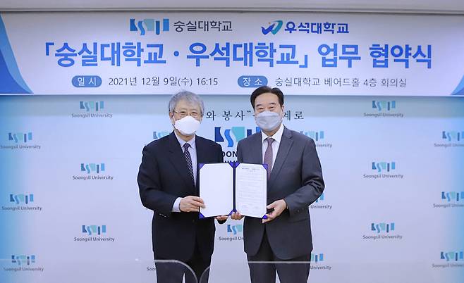 장범식 숭실대 총장(사진 왼쪽)과 남천현 우석대 총장이 협약서를 들고 기념촬영을 하고 있다.