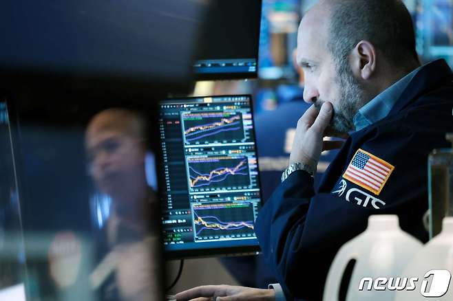 13일(현지시간) 미국 뉴욕시 뉴욕증권거래소(NYSE)에서 한 남성이 증시 상황을 지켜보고 있다. 2021.12.13 © AFP=뉴스1
