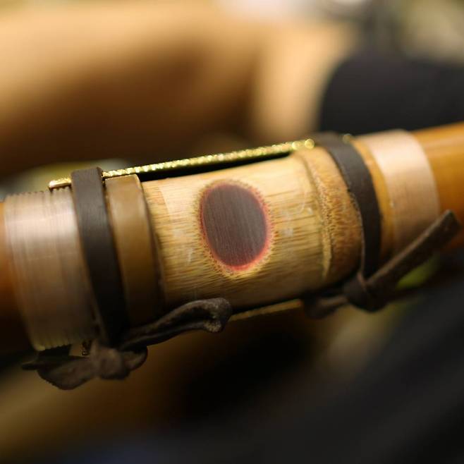 A close-up view of Won Jang-hyun’s daegeum cheong, a translucent membrane from reed grass, which vibrates when the large bamboo flute is played.  Photo © Hyungwon Kang