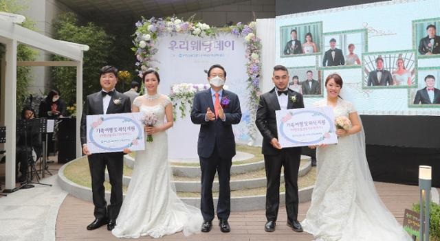 우리금융그룹 우리다문화장학재단은 지난해 10월 30일 서울 중구 소재 우리은행 본점에 마련된 자연친화적 정원 '숨터' 에서 다문화부부를 위한 결혼식 ‘제10회 우리웨딩데이’를 개최했다. 우리다문화장학재단 손태승 이사장(가운데)이 다문화 부부들과 기념촬영을 하고 있다. 우리금융그룹 제공