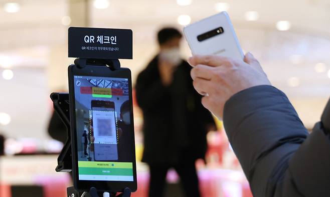 14일 서울 중구 롯데백화점 본점에서 고객이 방역패스 확인절차를 거치고 있다. 연합뉴스