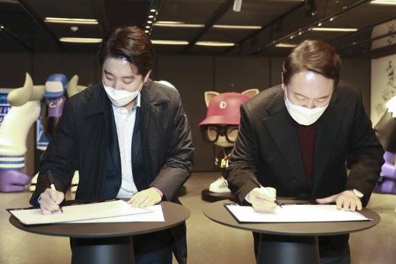 국민의힘 윤석열 대선 후보(오른쪽)와 이준석 대표가 지난 12일 서울 종로구 그랑서울타워에서 열린 온라인게임 '리그오브레전드 챔피언스 코리아(LCK) 2022 스프링' 개막전 관전에 앞서 방명록을 쓰고 있다. /사진=뉴스1화상