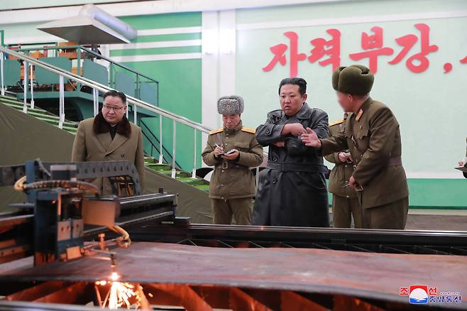 North Korean leader Kim Jong-un (center) inspects a munitions factory, in this photo released by the North's official Korean Central News Agency on Friday. (KCNA-Yonhap)