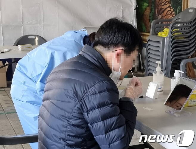 29일 충남 천안 임시선별진료소에서 한 시민이 자가진단키트를 이용해 코로나19 검사를 하고 있다.© 뉴스1