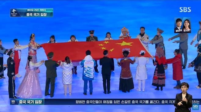 4일(현지 시각) 오후 베이징동계올림픽 개회식에서 한복을 입은 여성이 중국 국기인 '오성홍기'를 전달하고 있다. /SBS 캡처