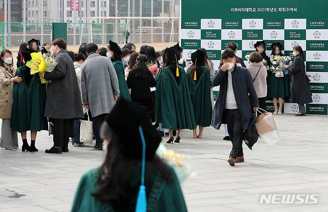 [서울=뉴시스] 백동현 기자 = 이화여대 20221학년도 전기 학위수여식이 개최된 28일 오후 서울 서대문구 이화여자대학교 포토월에서 졸업생들이 사진을 찍기 위해 길게 줄 서 있다. 2022.02.28. livertrent@newsis.com