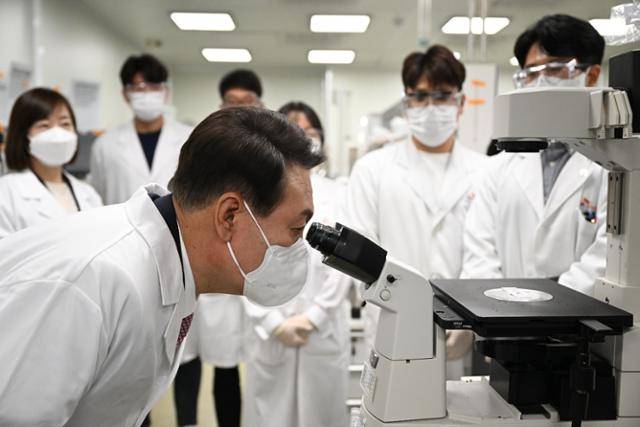 윤석열 대통령 당선인이 지난달 25일 오전 경기 성남시 SK바이오사이언스를 방문해 연구실의 광학현미경을 들여다보고 있다. 당선인 대변인실 제공