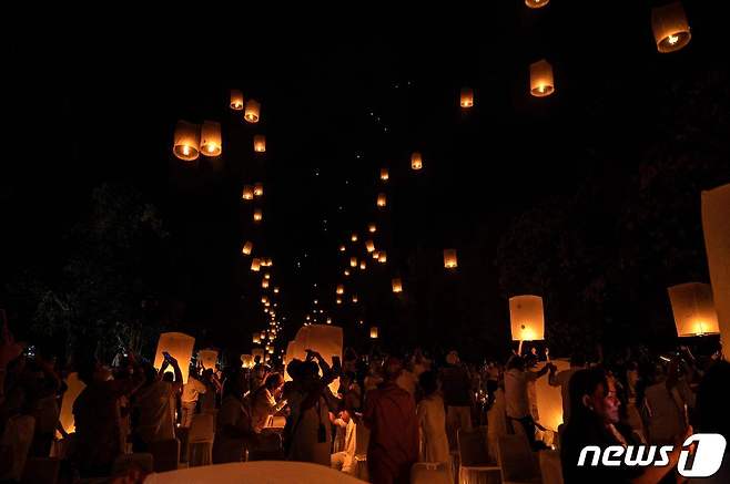 16일(현지시간) 인도네시아 자바의 마겔랑에 있는 보로부두르 사원에서 열린 베삭 데이 기념식에서 불교 승려들과 신자들이 등불을 띄우고 있다. © AFP=뉴스1 © News1 김예슬 기자